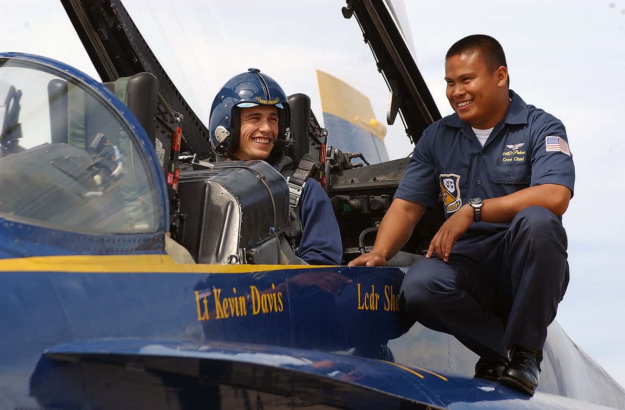 Actor James Franco shares a laugh with Aviation Machinist's Mate 1st Class Patrick Palma
