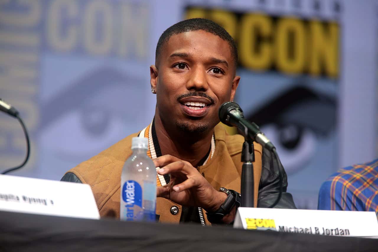 Michael_B._Jordan in a brown jacket