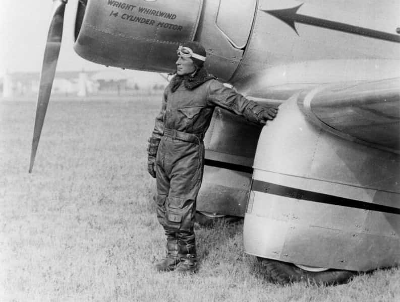 Pilot Aviation Sky Chief Frank Hawks standing next to plane