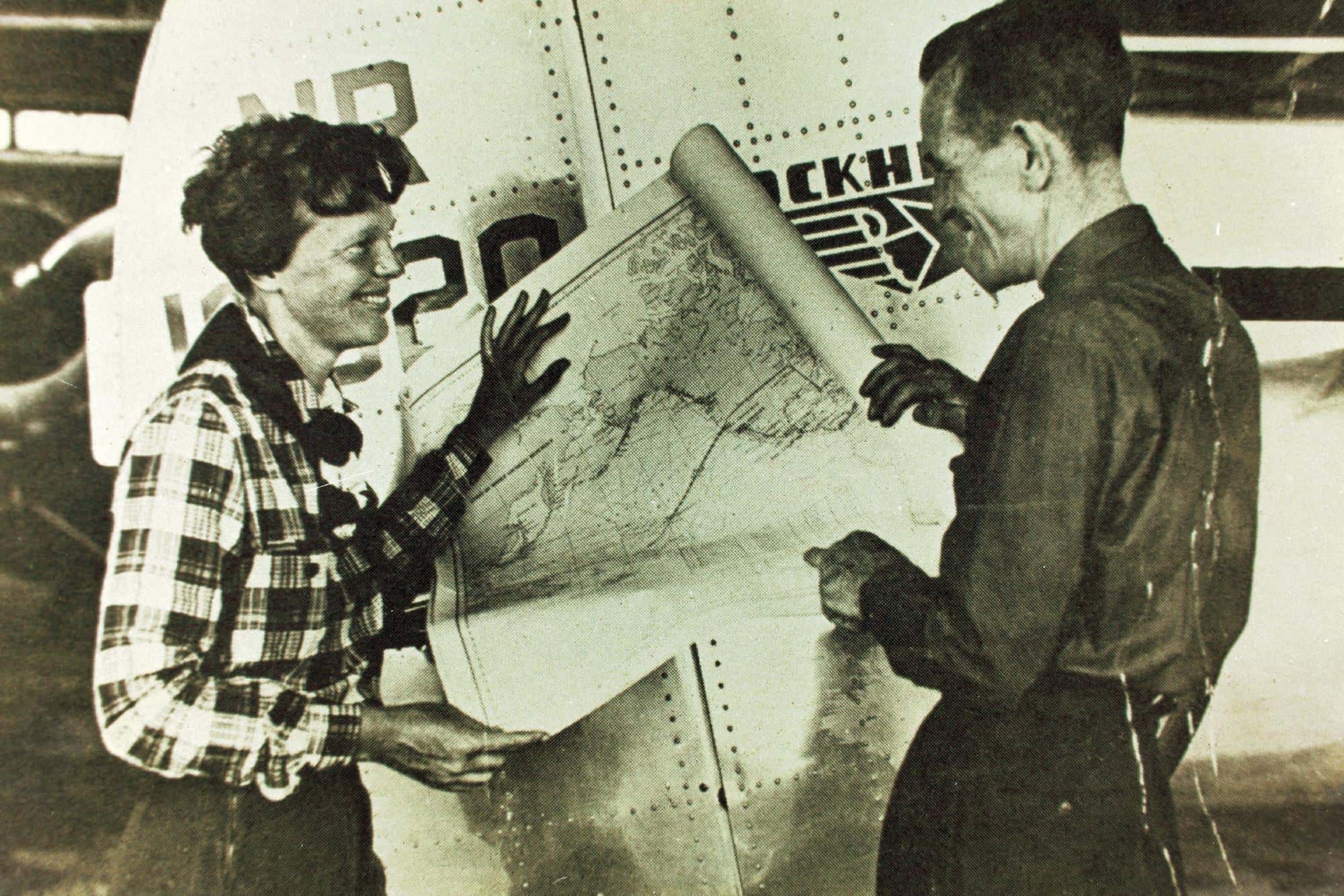 Amelia Earhart holding a map