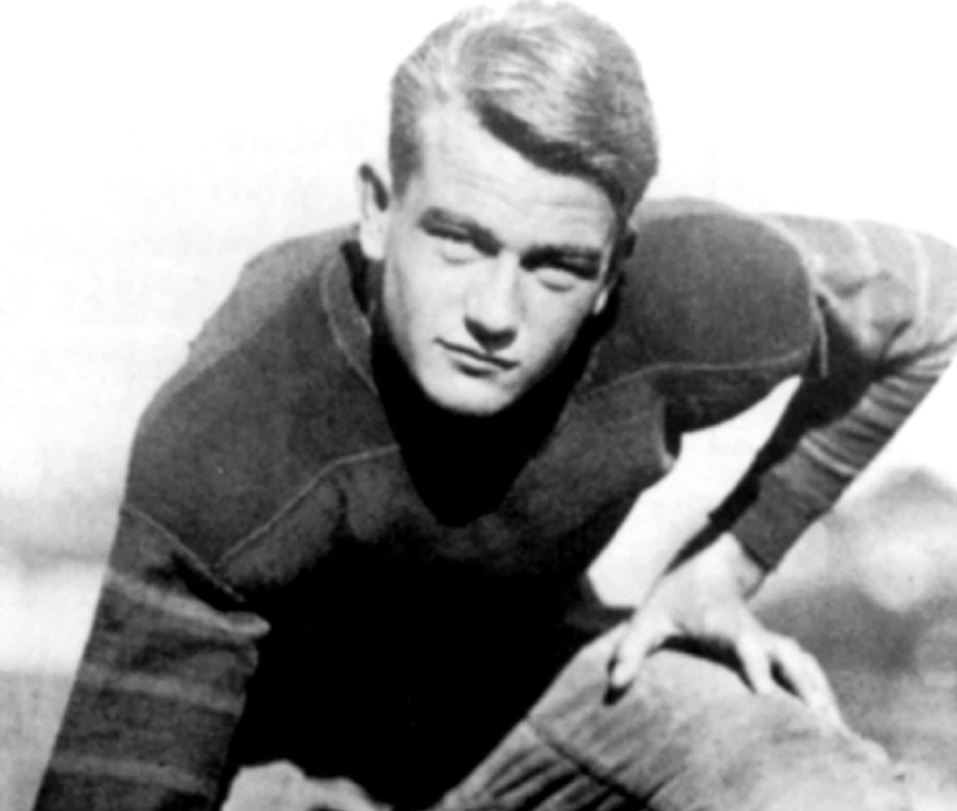 Portrait Photo of the actor John Wayne, wearing football outfit