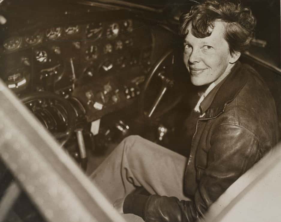 Photograph showing Amelia Earhart sitting in the cockpit