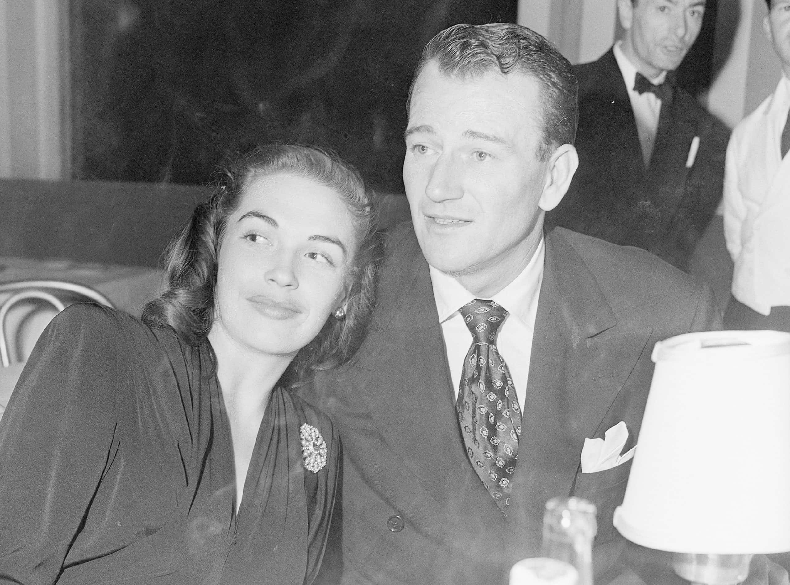 John Wayne and Esperanza Bauer at Club Trocadero, hugging each other