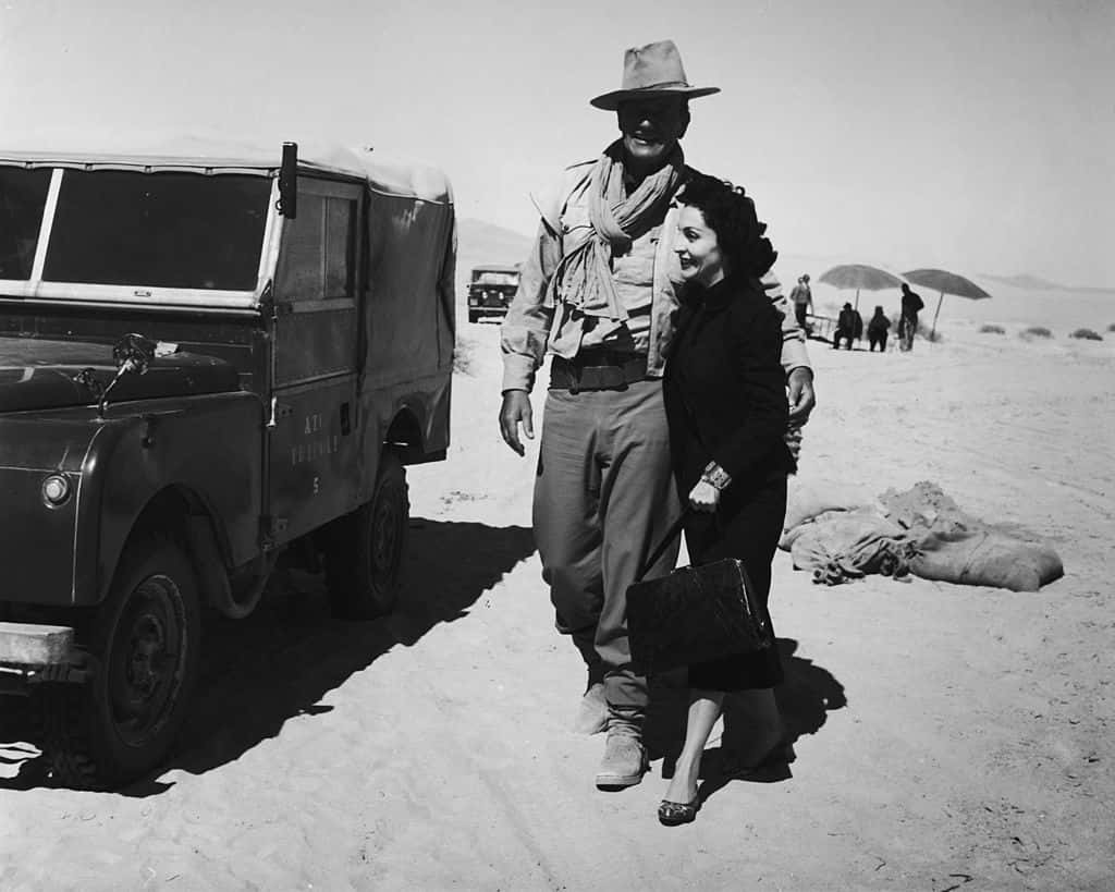 American actor John Wayne (1907 - 1979) with his wife Pilar during a location shoot in Libya for the film 'Legend of the Lost'