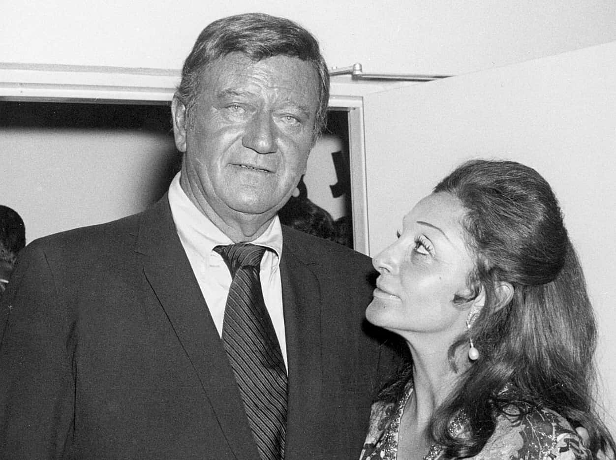 Pilar Wayne at the John Wayne Theatre opening at Knott's Berry Farm, hugging each other