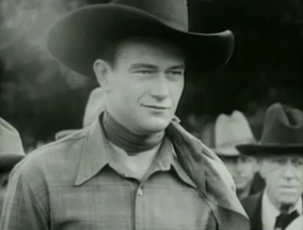 Portrait Photo of the actor John Wayne for film Riders of Destiny, wearing cowboy hat and cowboy outfit