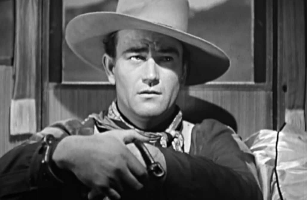 Portrait Photo of the actor John Wayne, wearing cowboy hat and cowboy outfit
