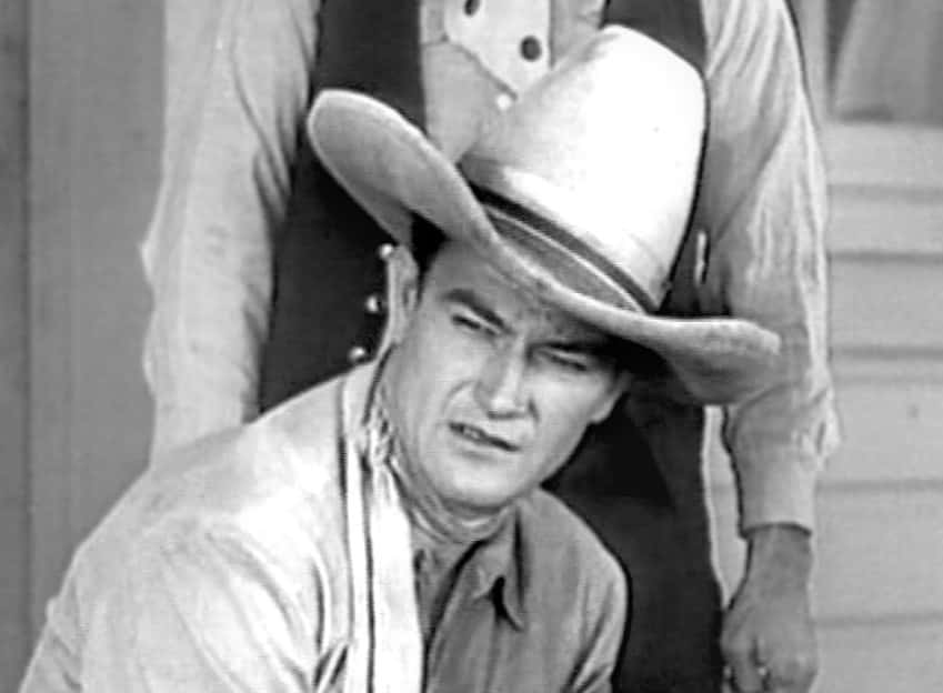 Portrait Photo of the actor John Wayne, wearing cowboy hat and cowboy outfit