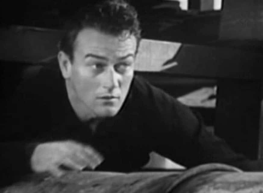 Snapshot of John Wayne from the Movie Sagebrush Trail, wearing a black shirt