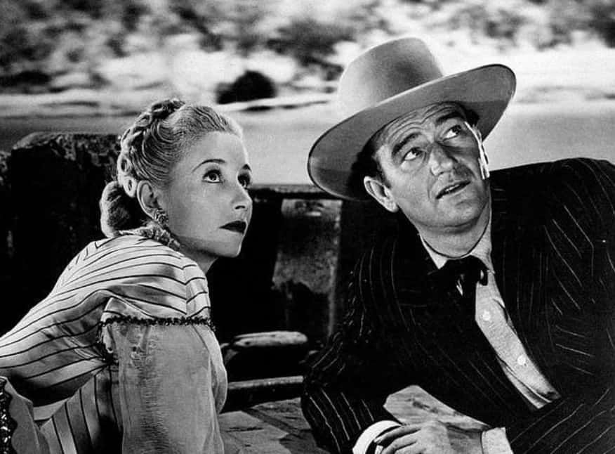 American actor John Wayne (Marion Mitchell Morrison) lying with Czechosclovak-born American actress and ice-skater Vera Ralston (Vera Helena Hruba)