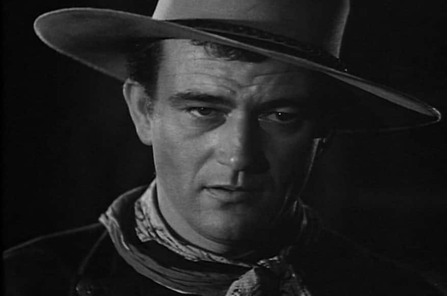 Portrait Photo of the actor John Wayne from the Movie The Ringo Kid, wearing cowboy hat and cowboy outfit