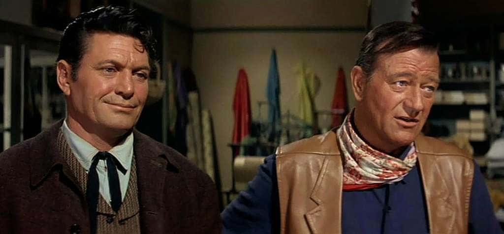 Chuck Roberson and John Wayne in the Movie McLintock! standing next to each other