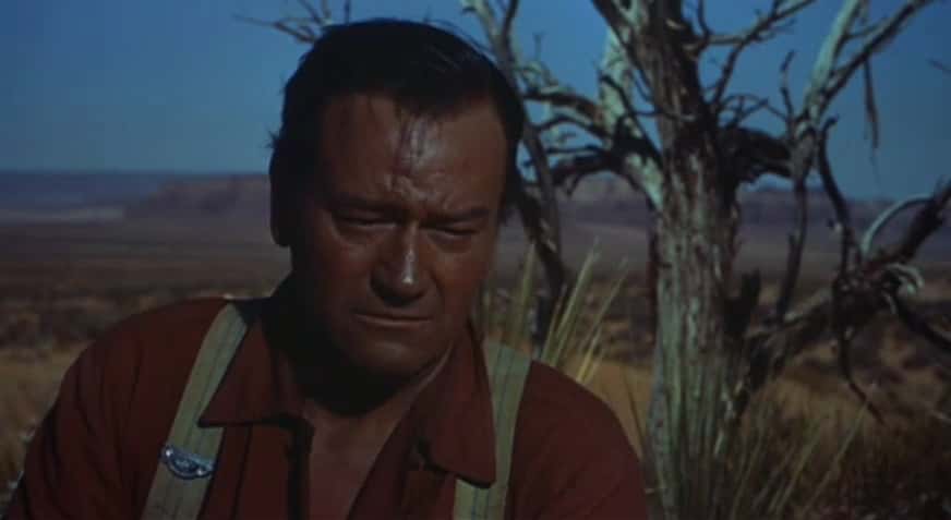 Portrait Photo of the actor John Wayne, wearing cowboy outfit, looking to the right