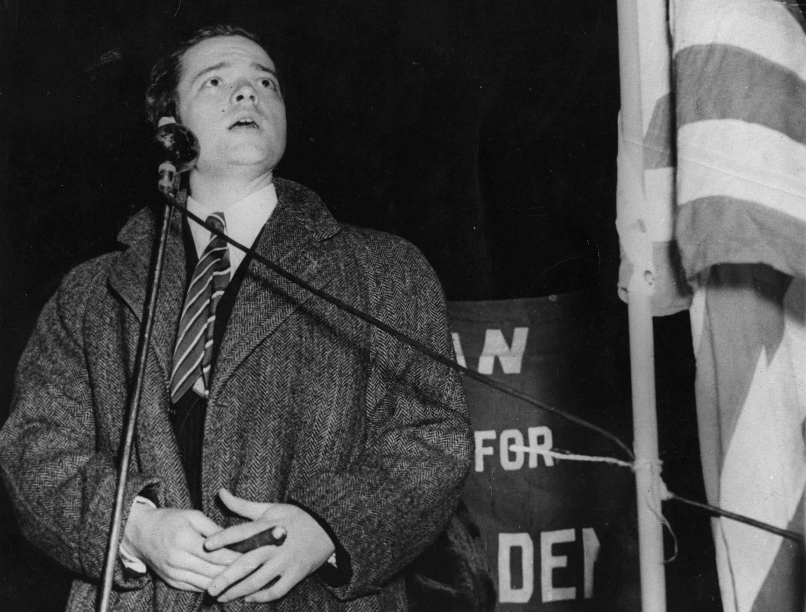 Orson Welles (1915 - 1985), broadcasting at a mass demonstration in New York