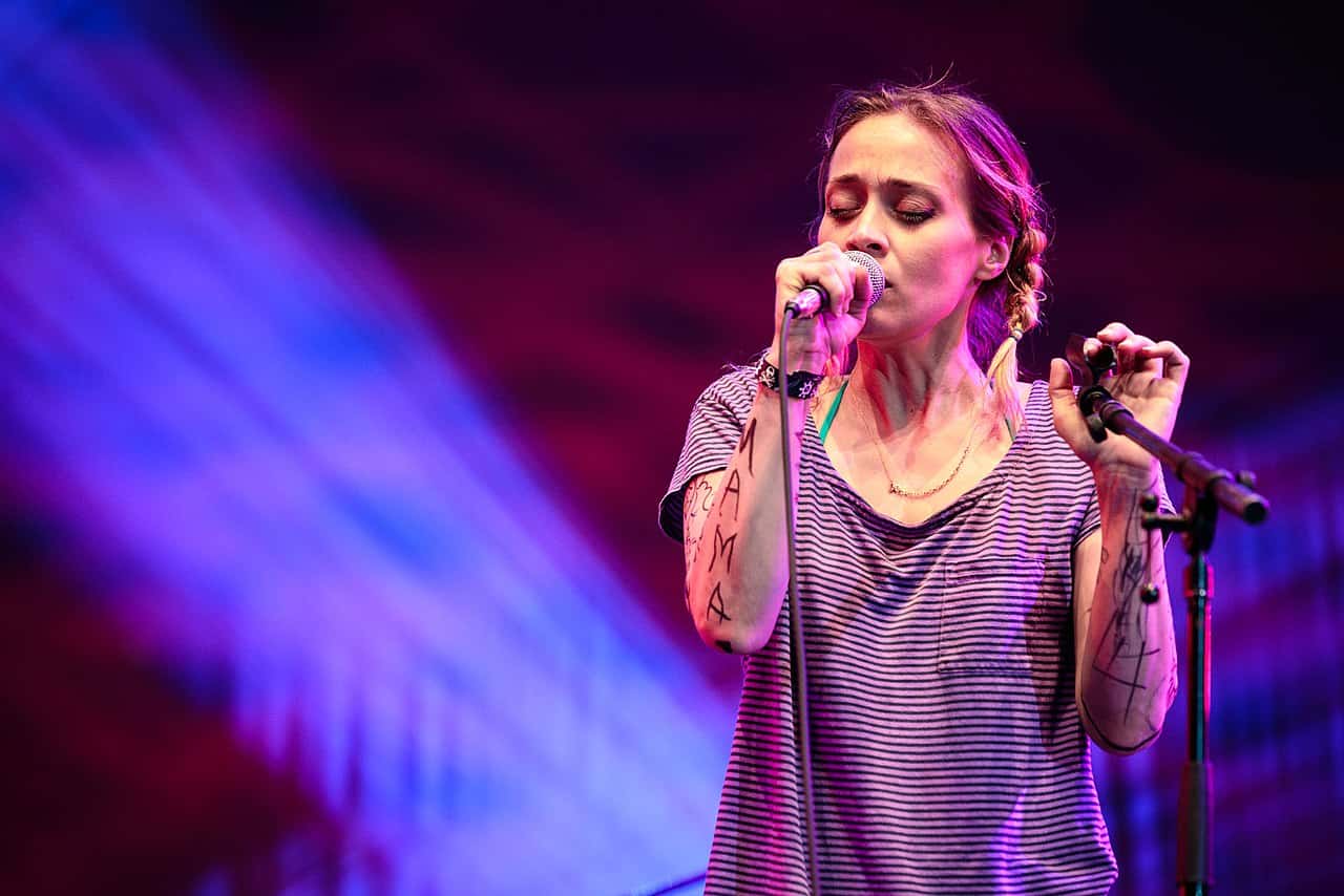 Fiona Apple singing on a microphone
