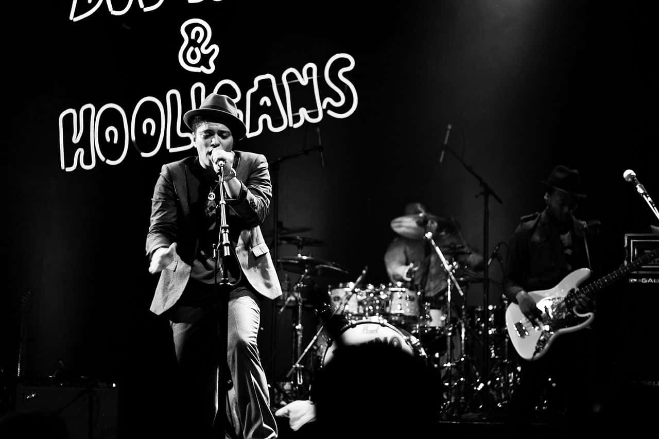 Grayscale Portrait Photo of Bruno Mars performing on stage