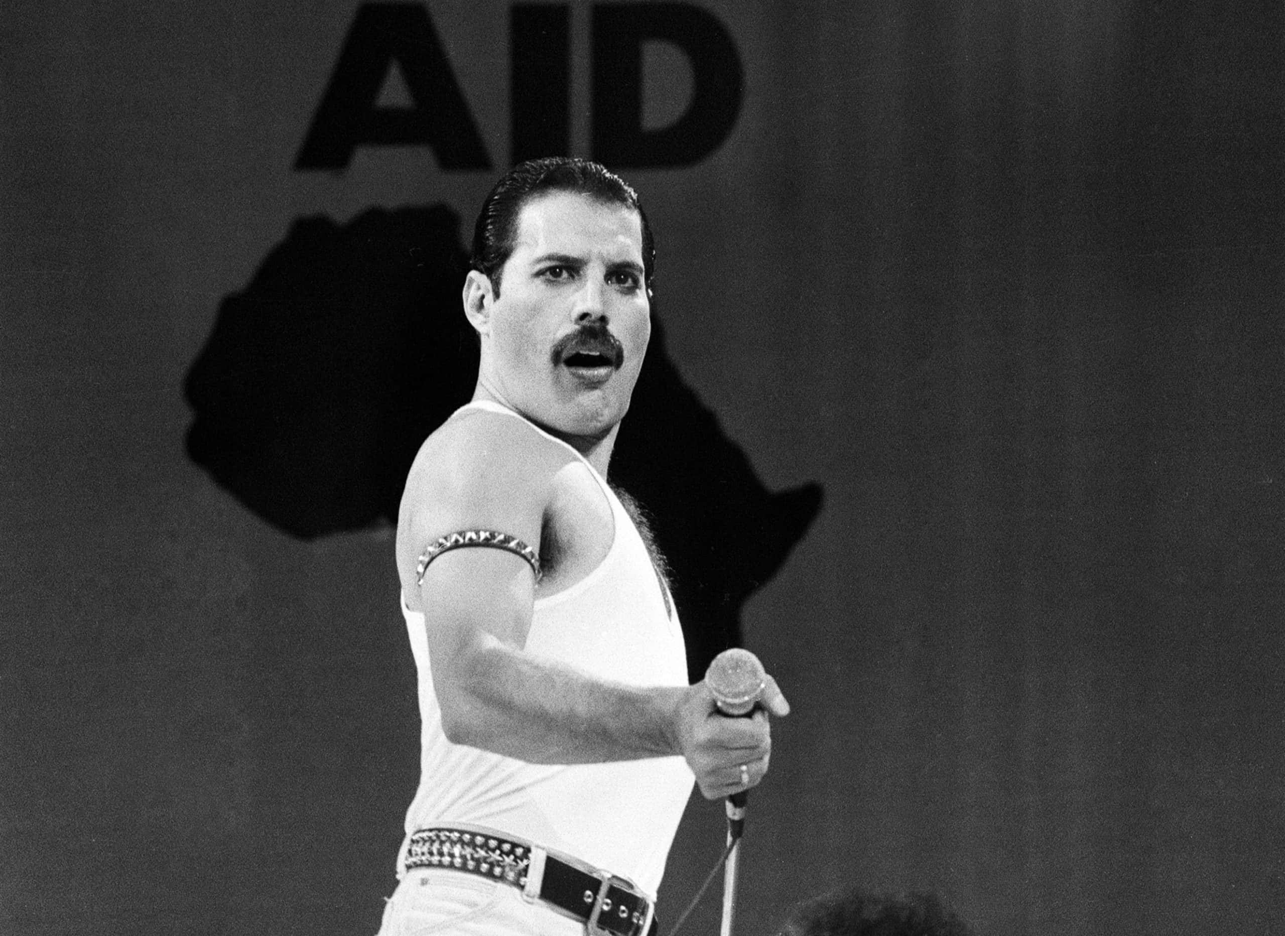 Freddie Mercury, lead singer of British rock group Queen, performing on stage