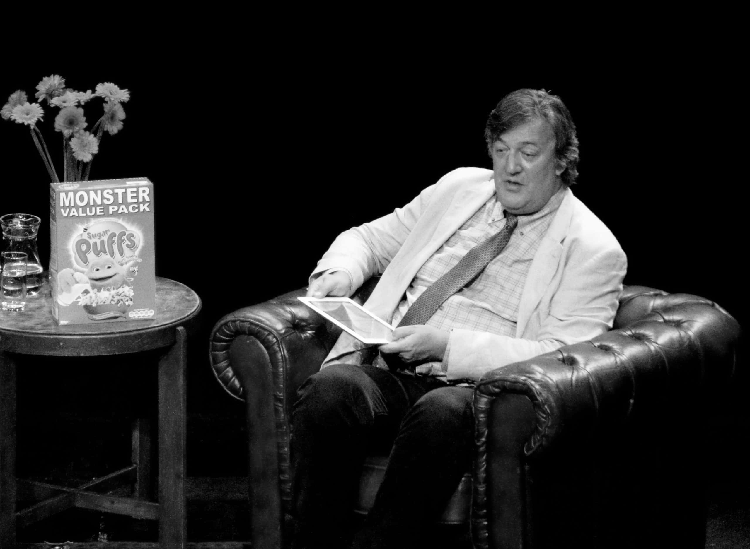 Grayscale Portrait Photo of Stephen Fry in white outfit