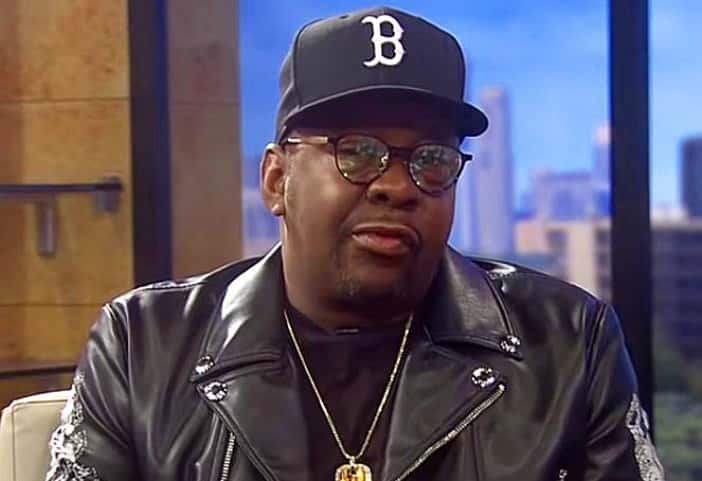 Bobby Brown wearing black leather jacket and black hat is looking at side - 2018