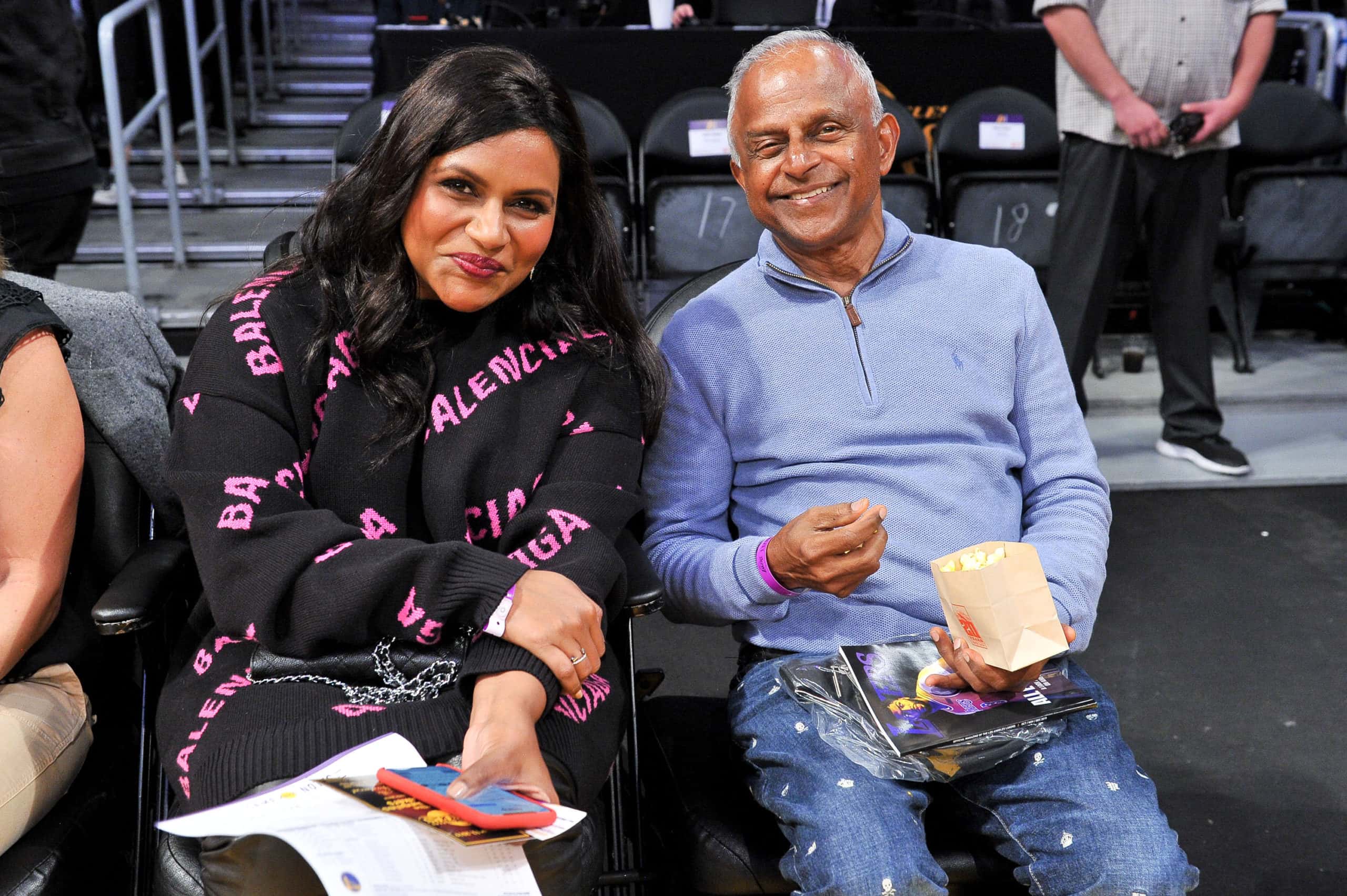 Mindy Kaling and her father Avu Chokalingam attend a basketball game