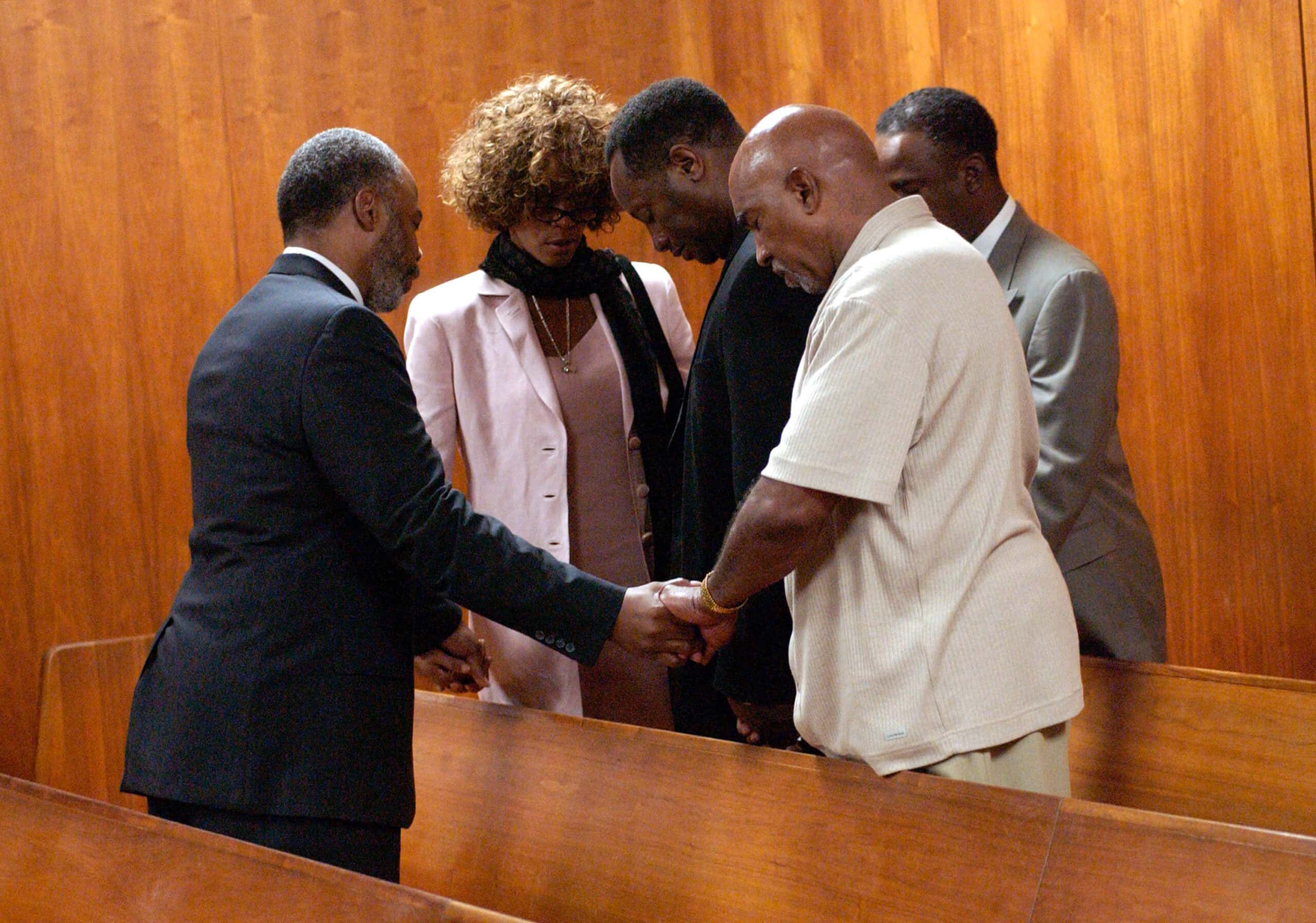 Chaplain Don Hughes (L) prays with Whitney Houston (2nd L) and the rest of her entourage - 2003