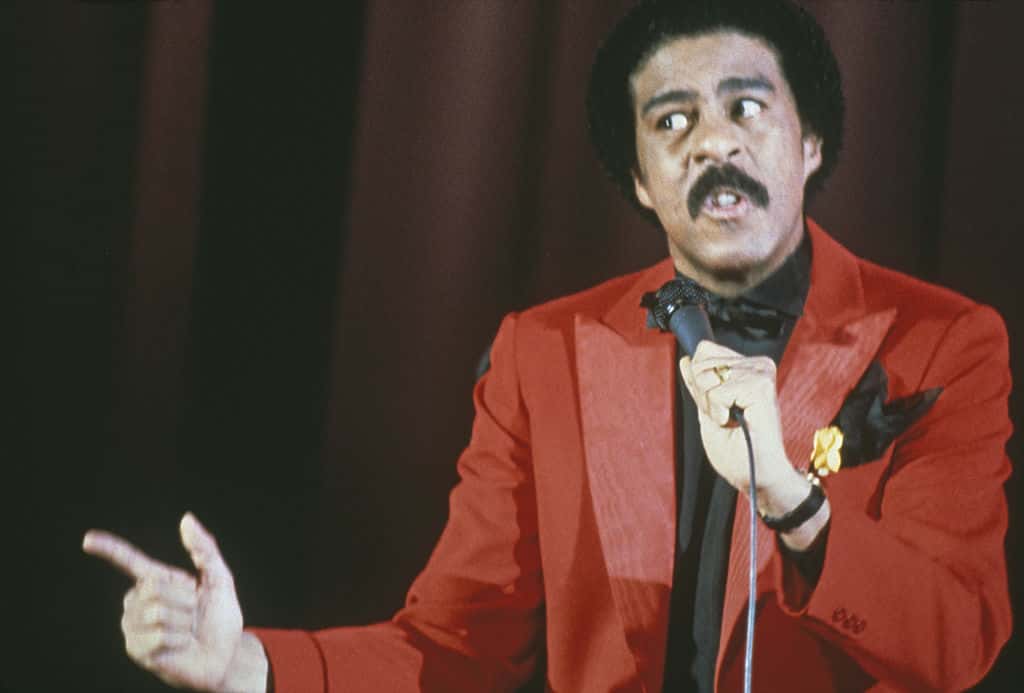 Portrait Photo of American comedian Richard Pryor in red outfit