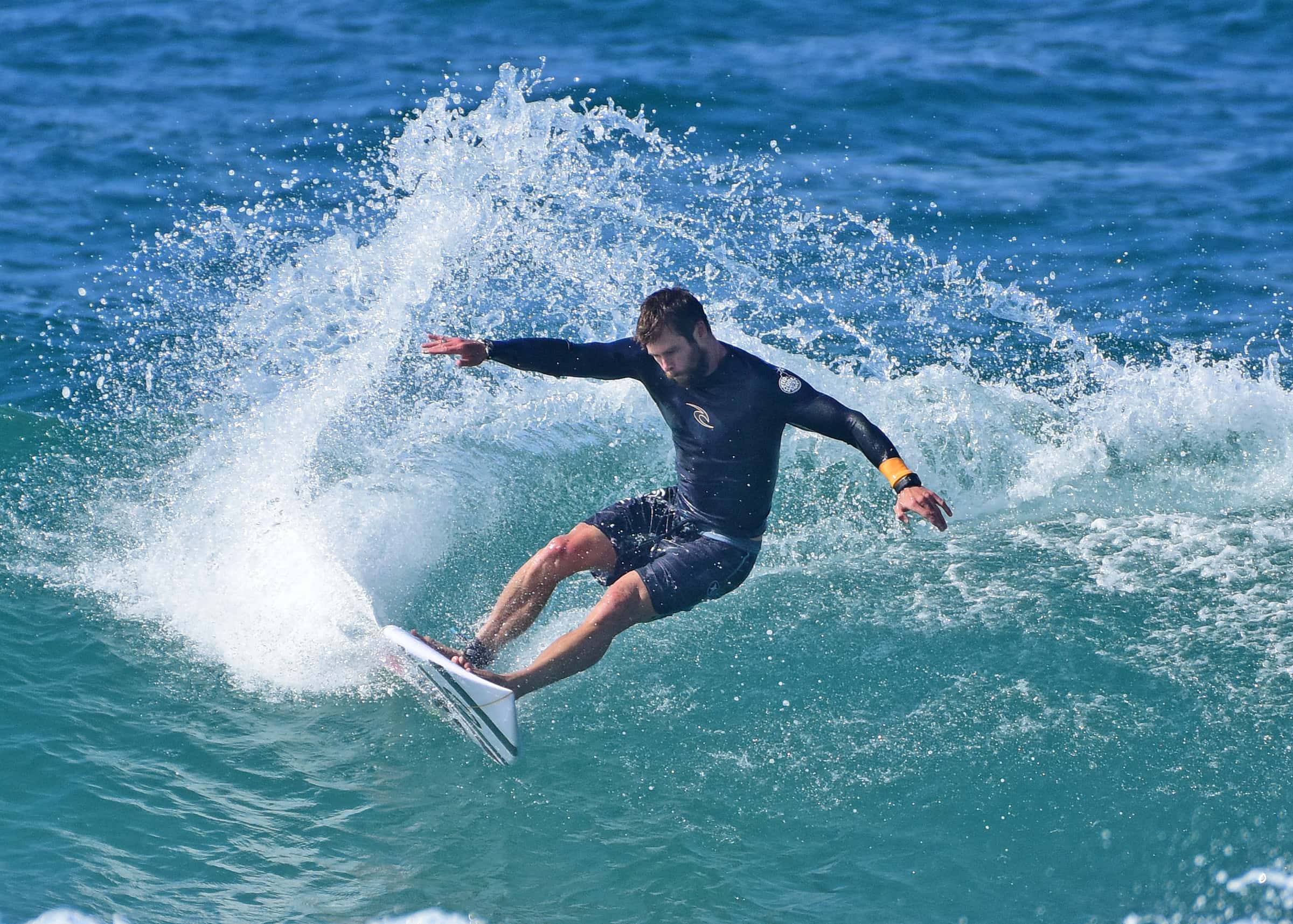 Chris Hemsworth is seen surfing and relaxing at the beach
