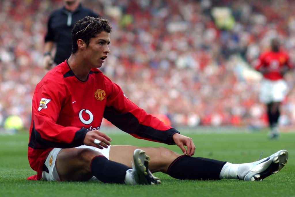 Portrait Photo of Cristiano Ronaldo, Manchester United, sitting on grass