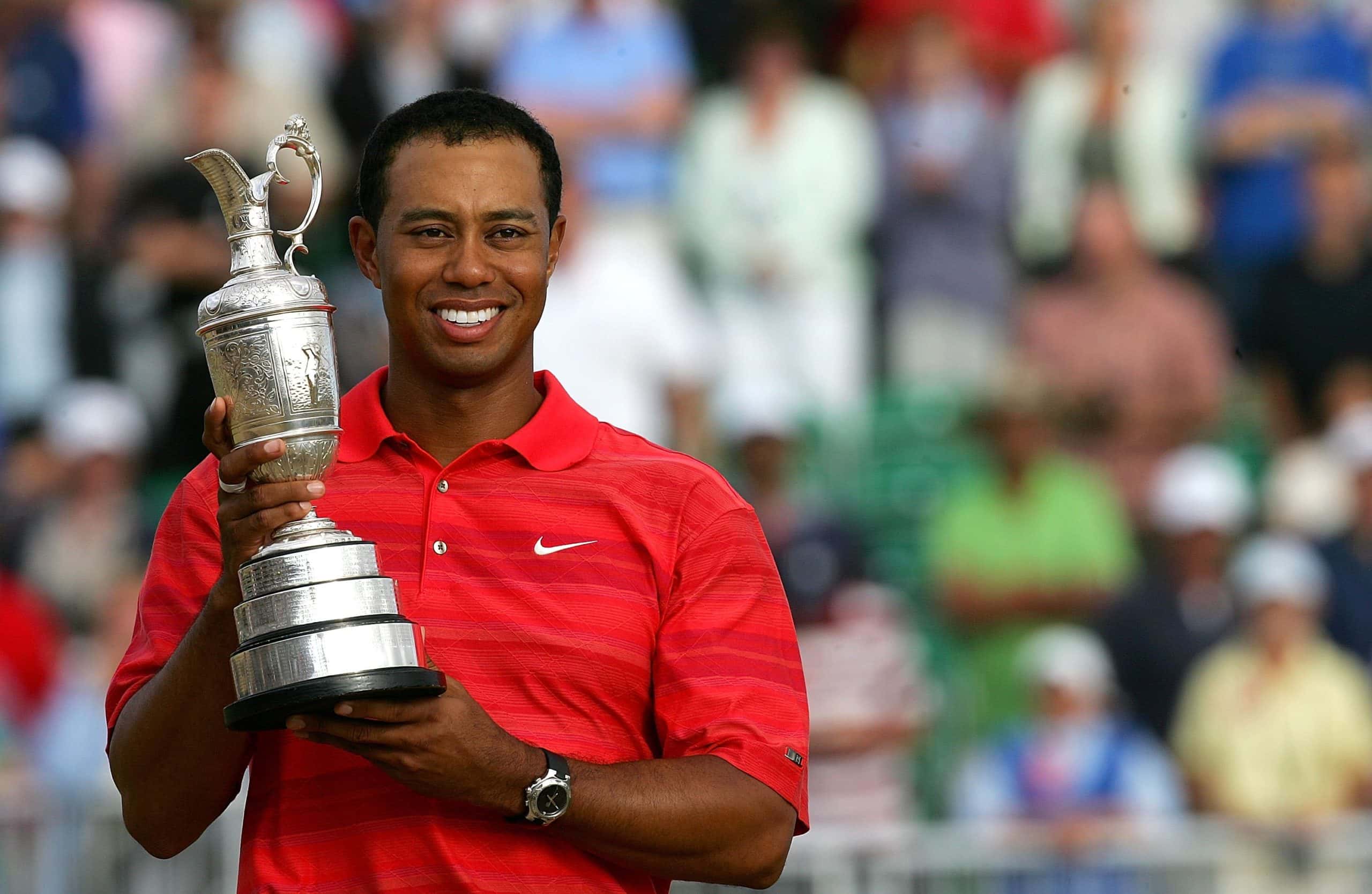 Tiger Woods of USA poses with the claret jug following his two shot victory