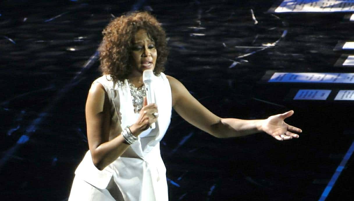 Whitney Houston in white jacket is performing live on stage - 2010