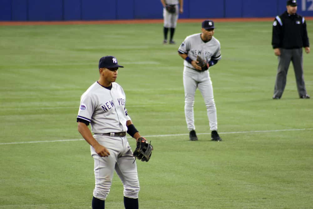 New York Yankees, Alex Rodriguez (L) and Derek Jeter (C), stand during a game against the Toronto Blue Jays