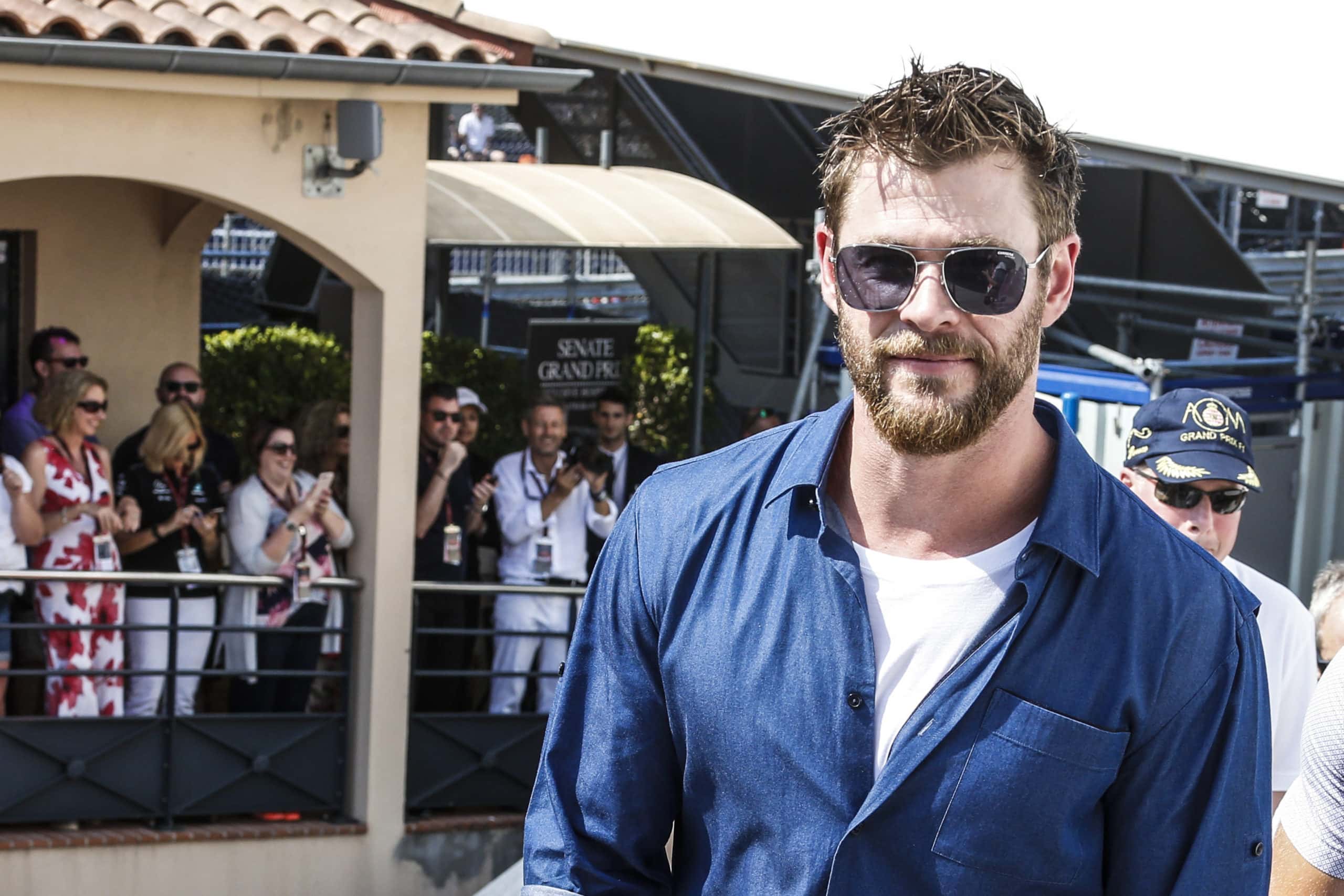 Chris Hemsworth wearing a blue shirt and a pair of sunglasses