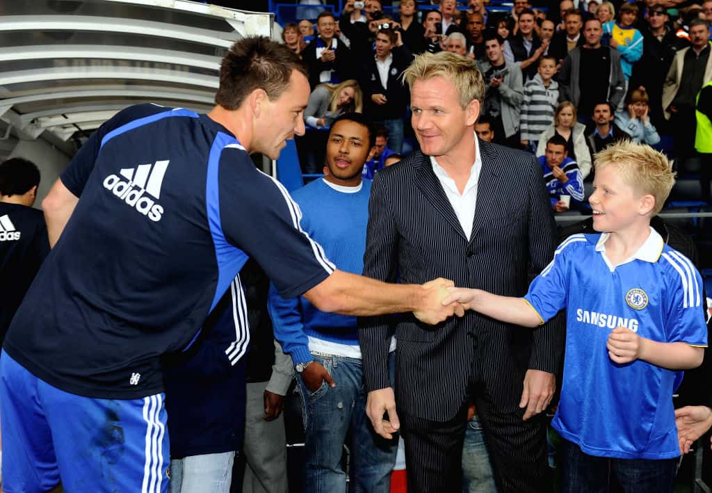 John Terry of Chelsea shakes hands with chef Gordon Ramsay's son Jack