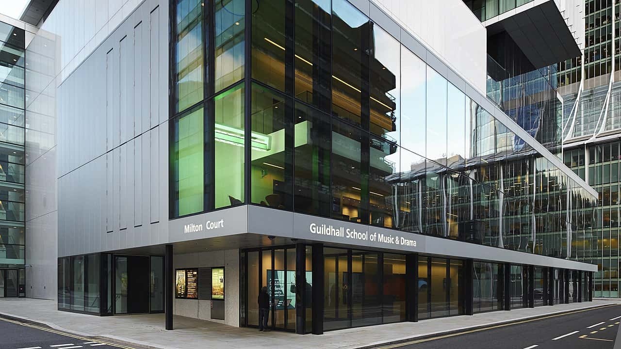 The image depicts the exterior facade of the Guildhall School of Music & Drama