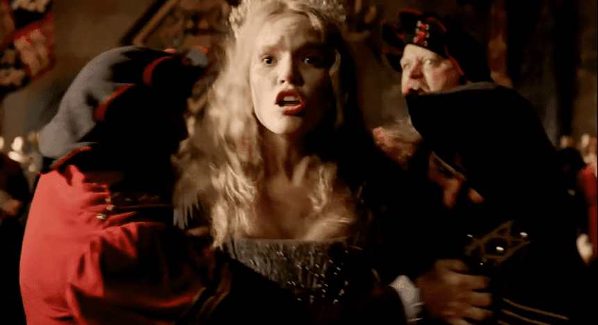Screenshot of Catherine Howard with long hair is yelling in front of other people - from The Tudors (2007–2010)