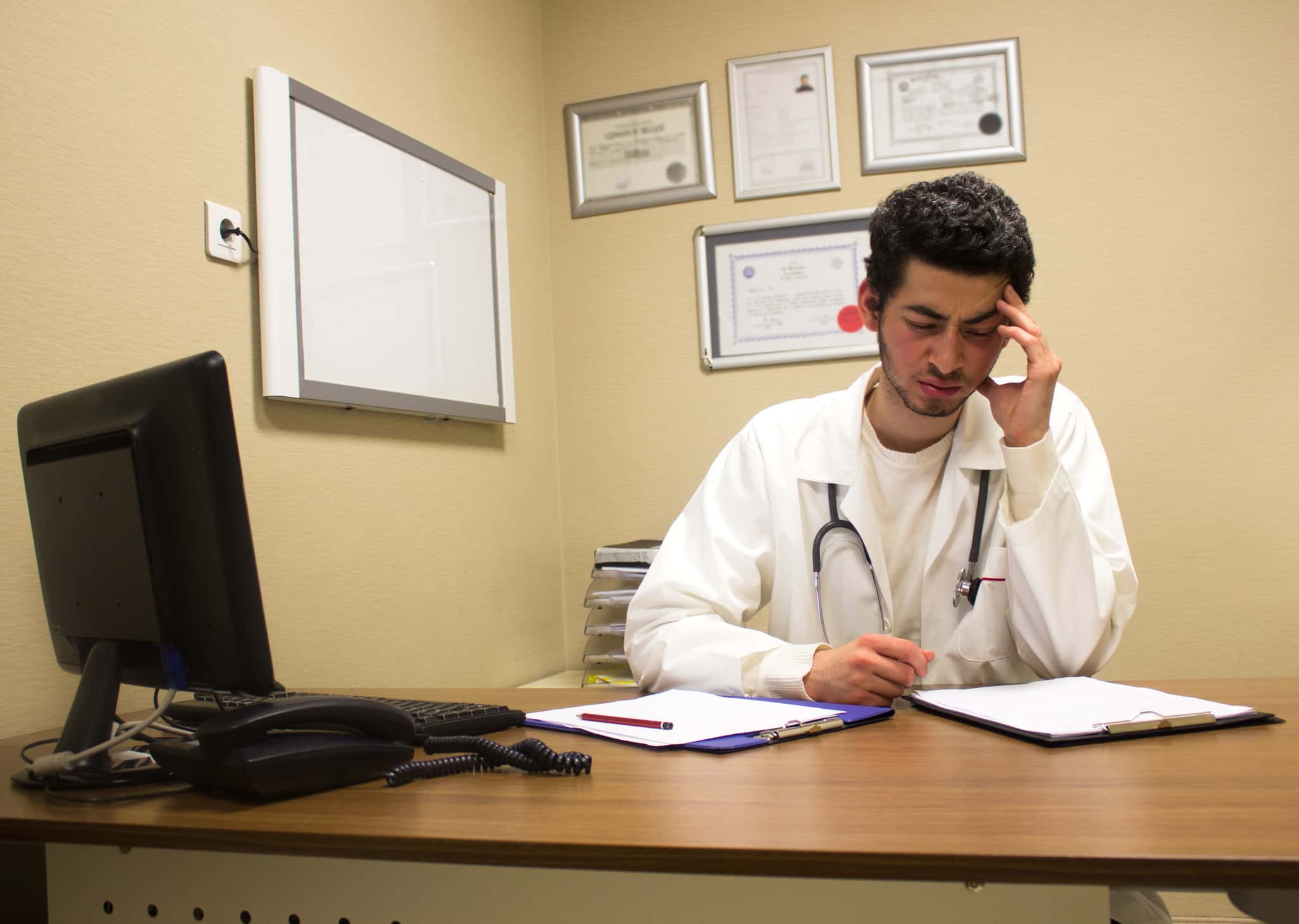 Stressed out doctor worried about his patient