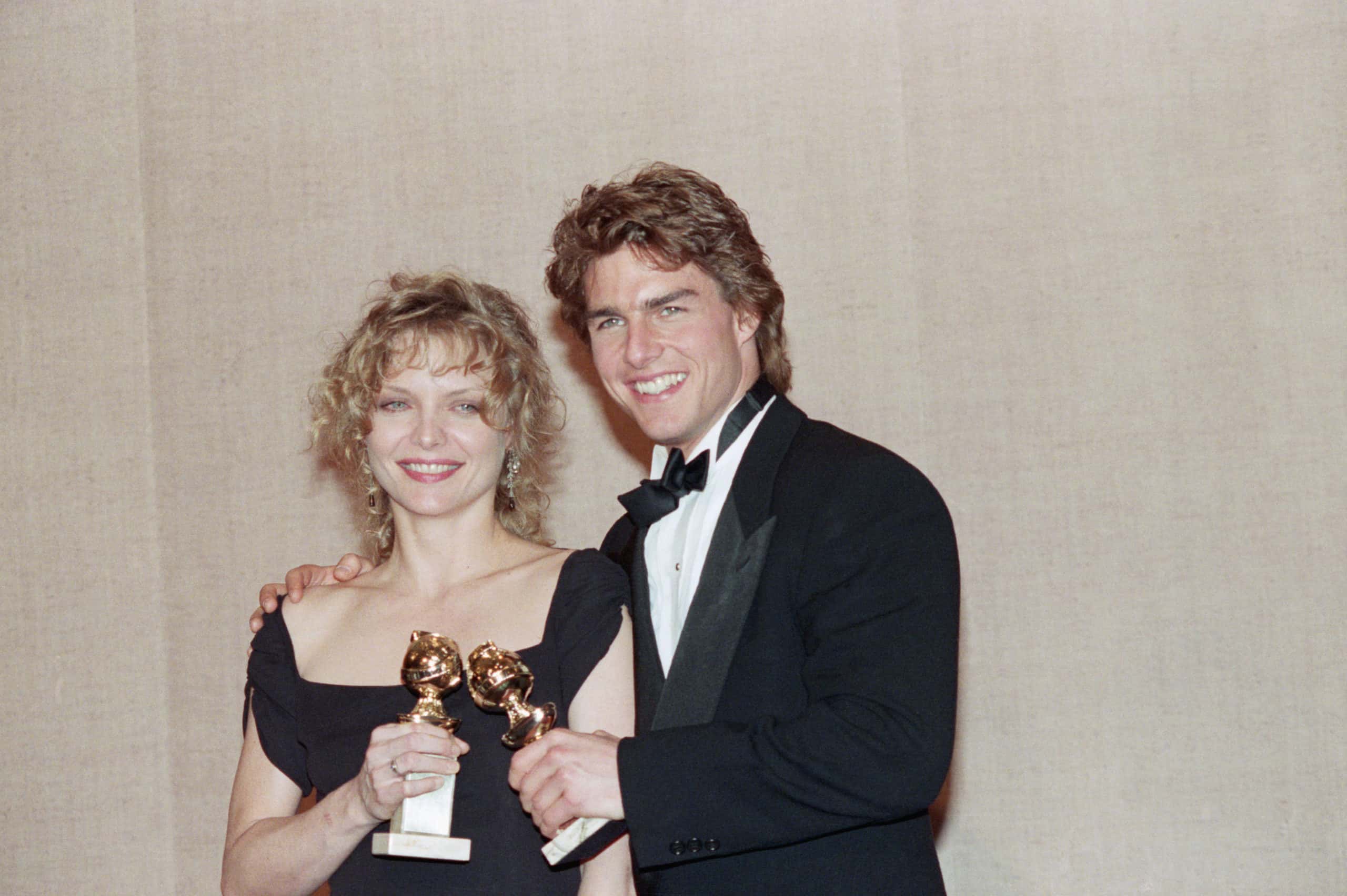 Actress Michelle Pfeiffer and actor Tom Cruise pose with their Golden Globe awards