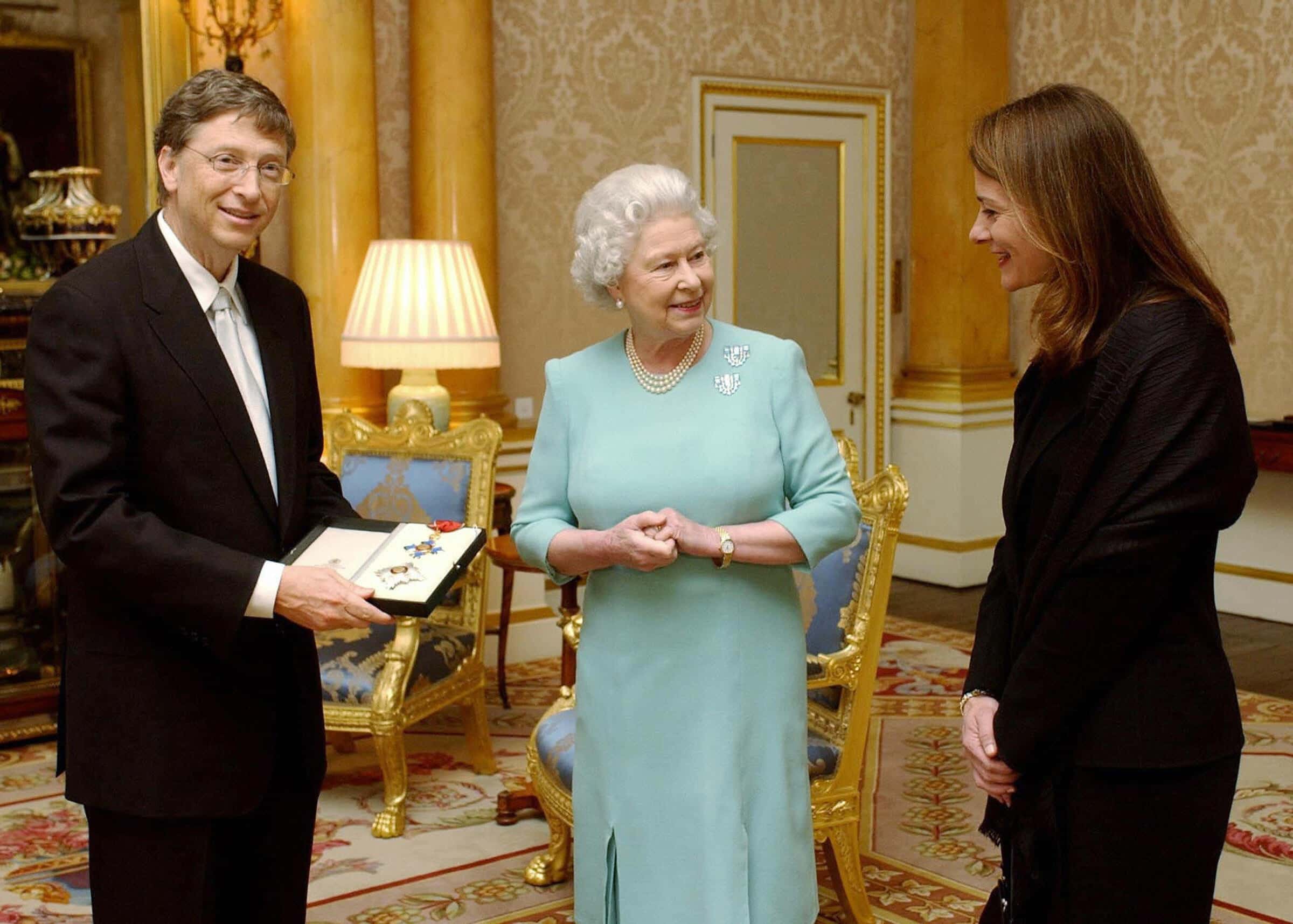 Britain's Queen Elizabeth II presents Microsoft tycoon Bill Gates with his honorary knighthood at Buckingham Palace
