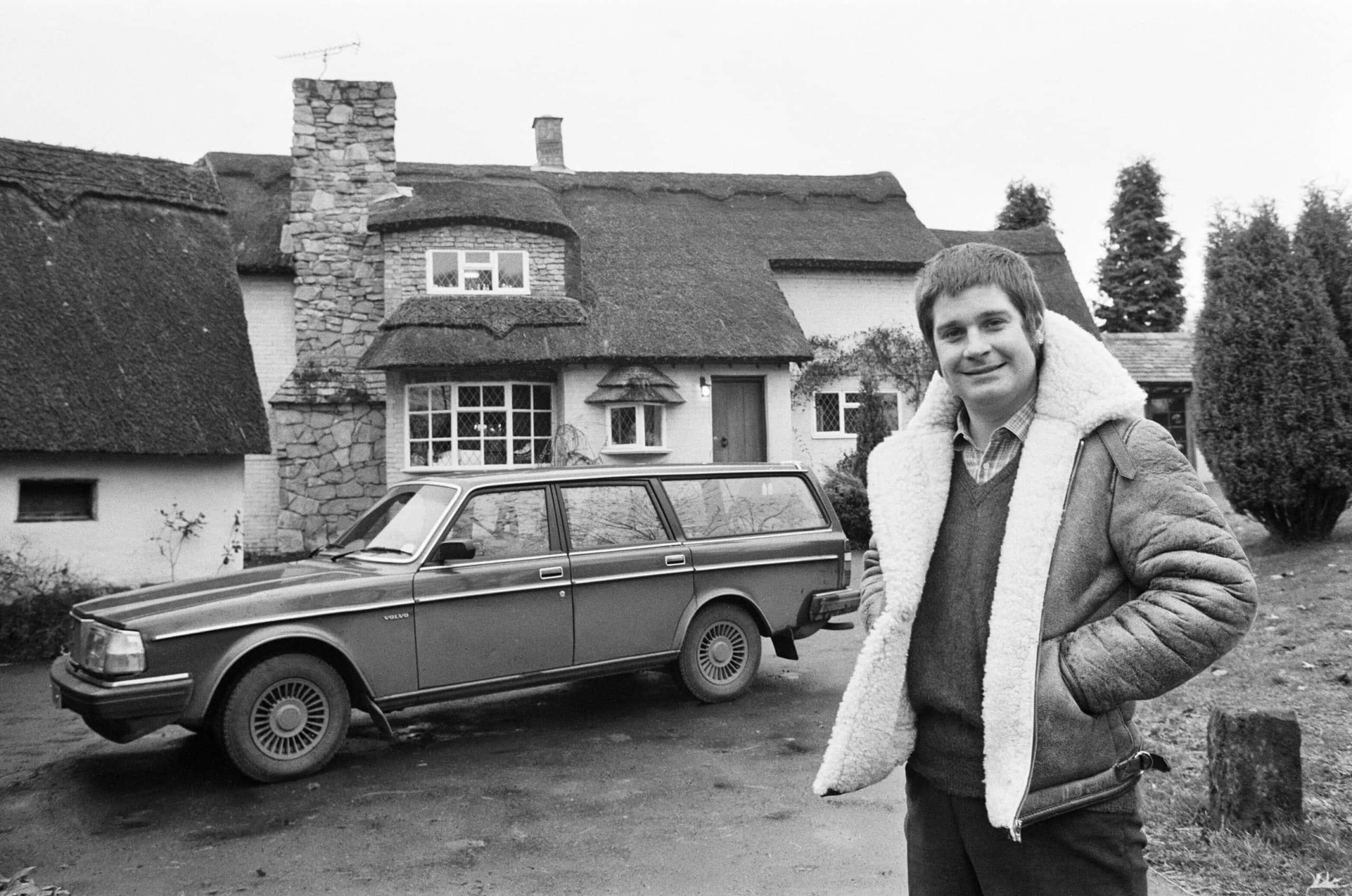 Black Sabbath singer Ozzy Osbourne pictured outside his new house, beside his Volvo car.