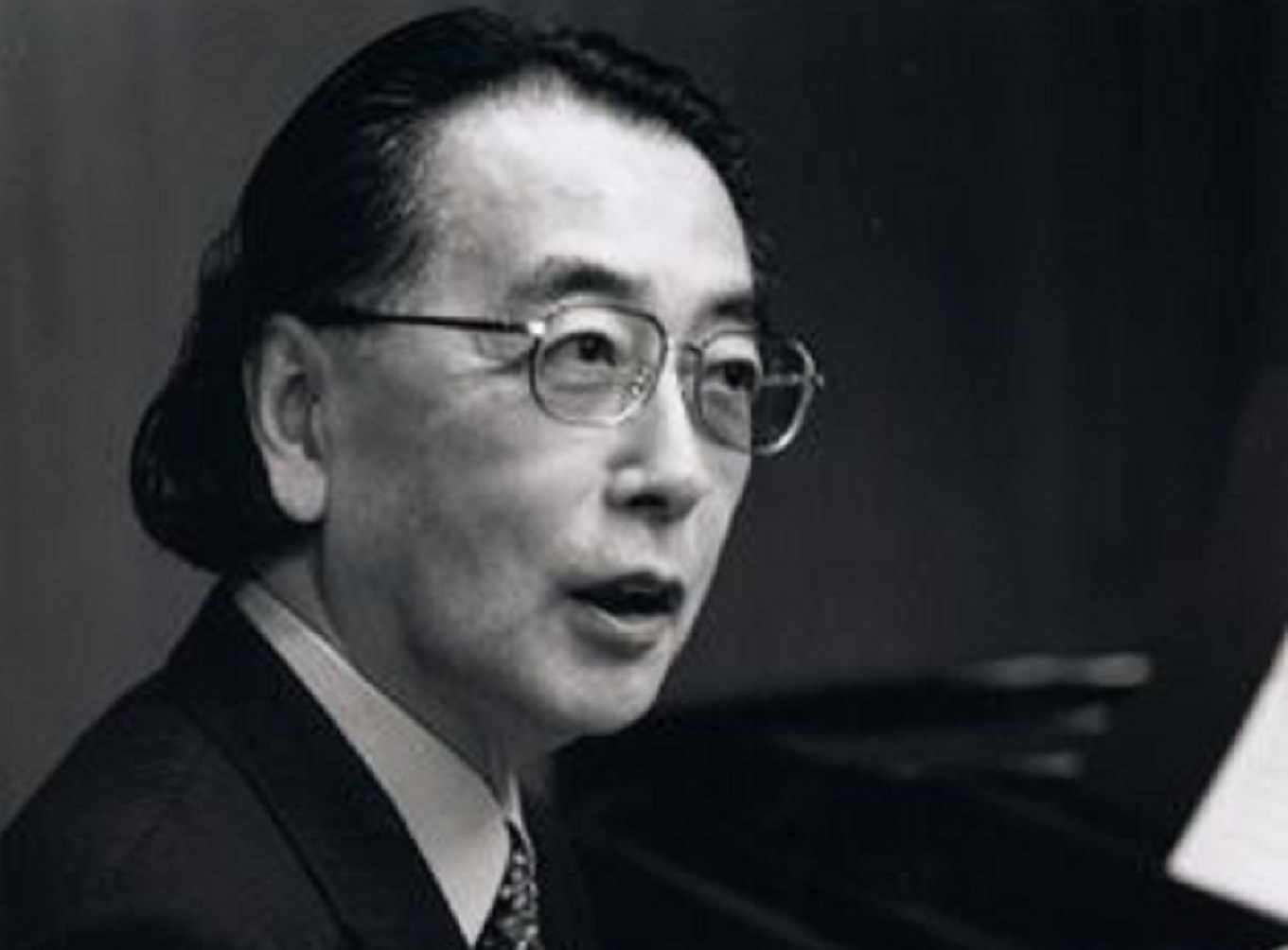 Grayscale Portrait Photo of Toshi Ichiyanagi in dark suit