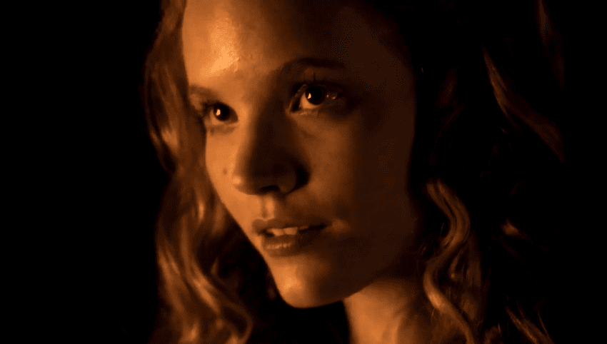 Screenshot of Catherine Howard with long hair looking at front in the dark - from The Tudors (2007–2010)