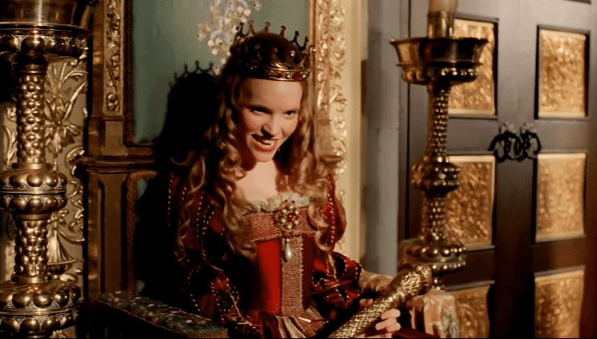 Screenshot of Catherine Howard with long hair looking at front ,wearing crown and red dress - from The Tudors (2007–2010)
