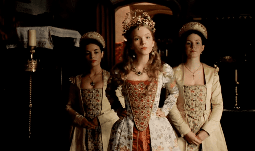Screenshot of Catherine Howard with long hair wearing white and red dress is looking at front - from The Tudors (2007–2010)