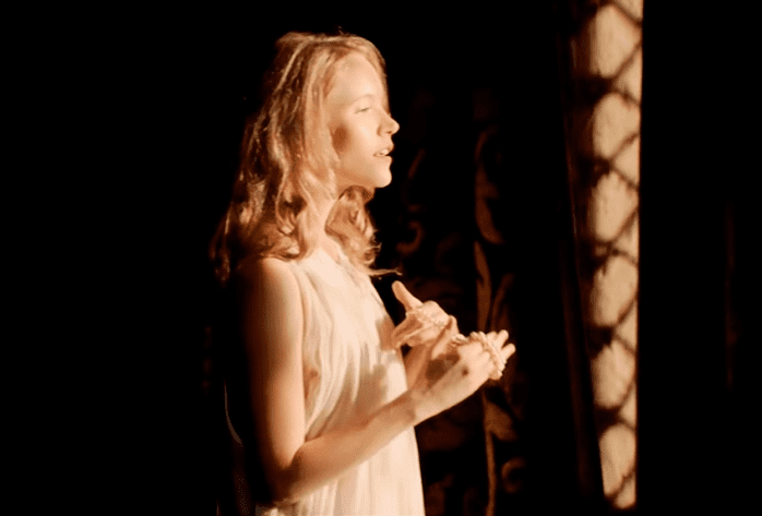 Screenshot of Catherine Howard with long hair looking thru window - from The Tudors (2007–2010)