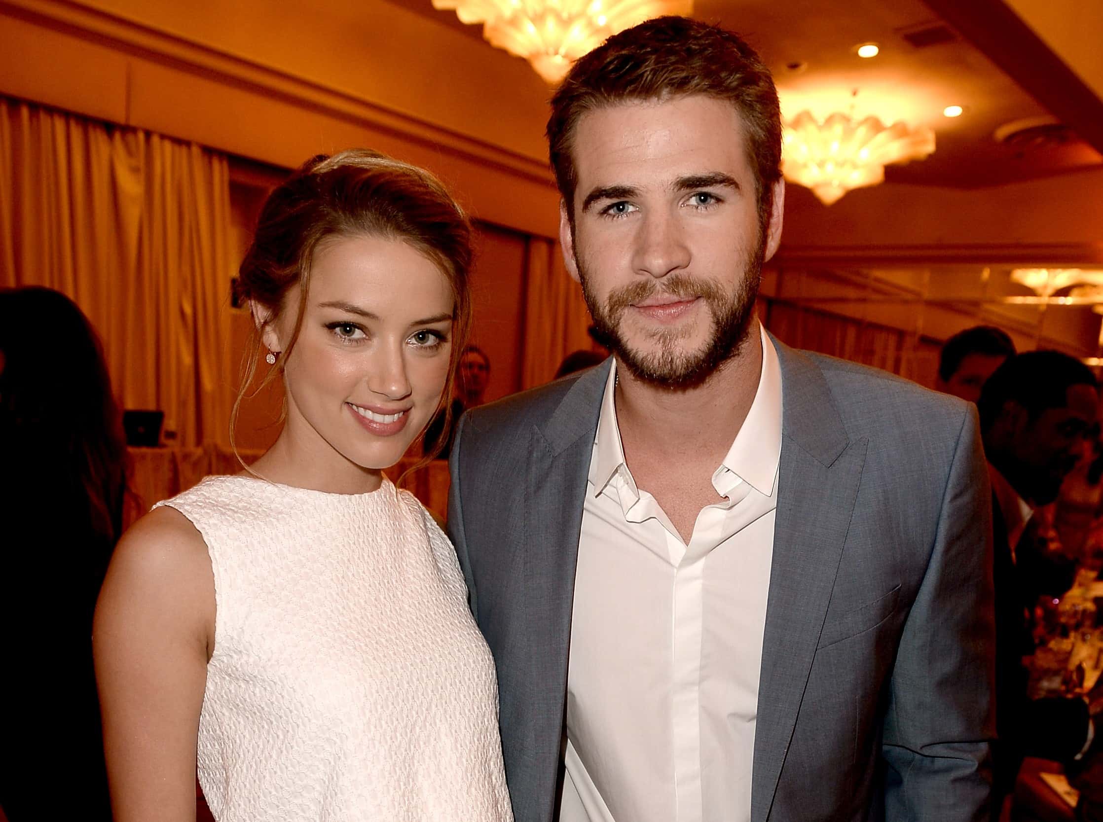 Actors Amber Heard (L) and Liam Hemsworth attend the Hollywood Foreign Press Association's 2013 