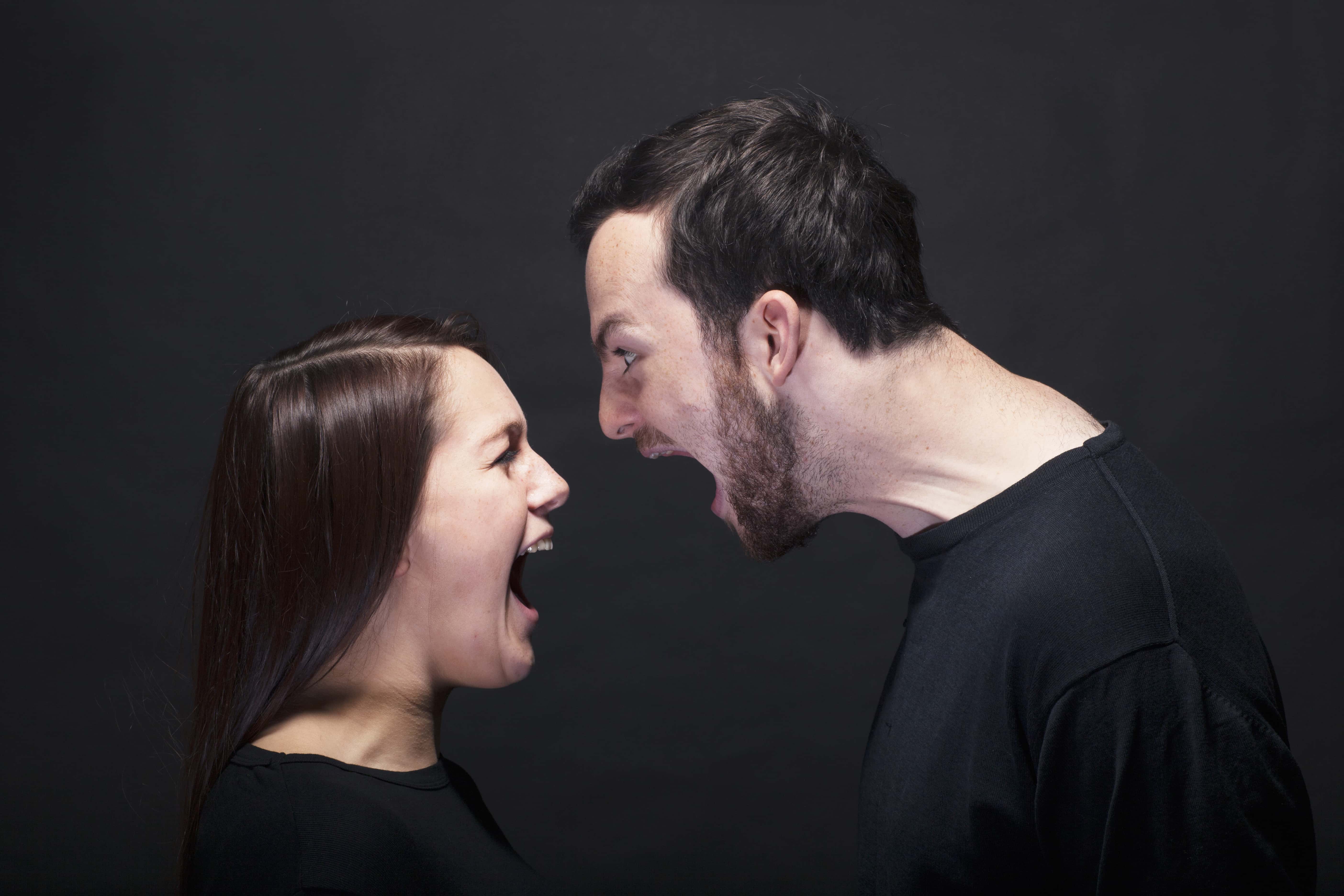 Young man and woman shouting at each other.