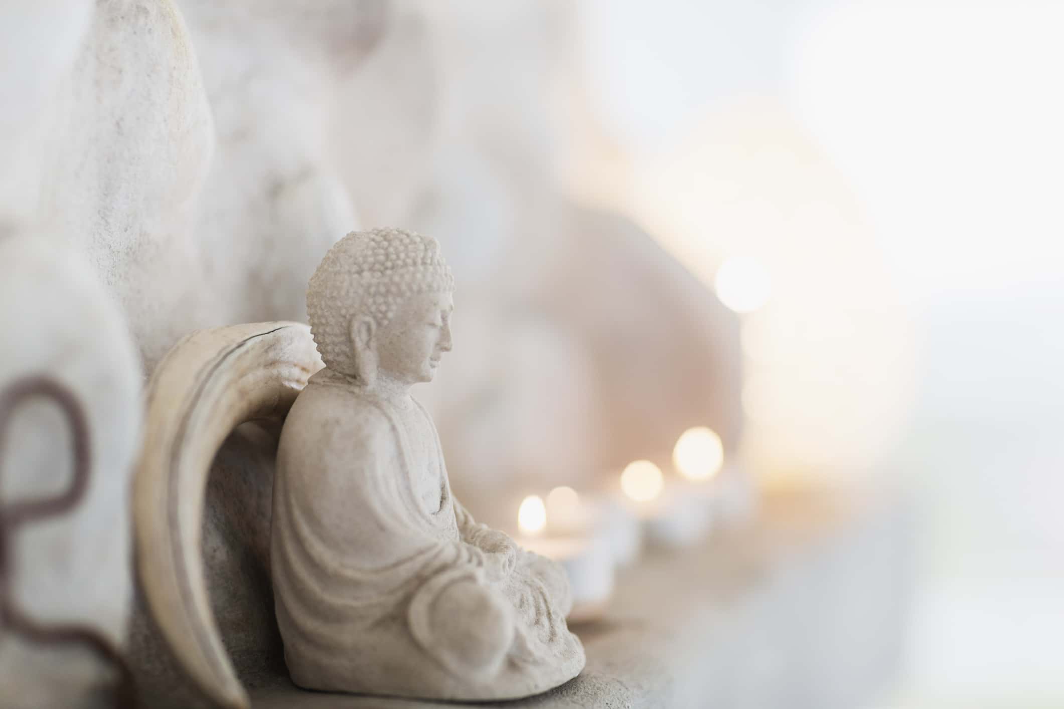 Buddha figurine and candles on ledge
