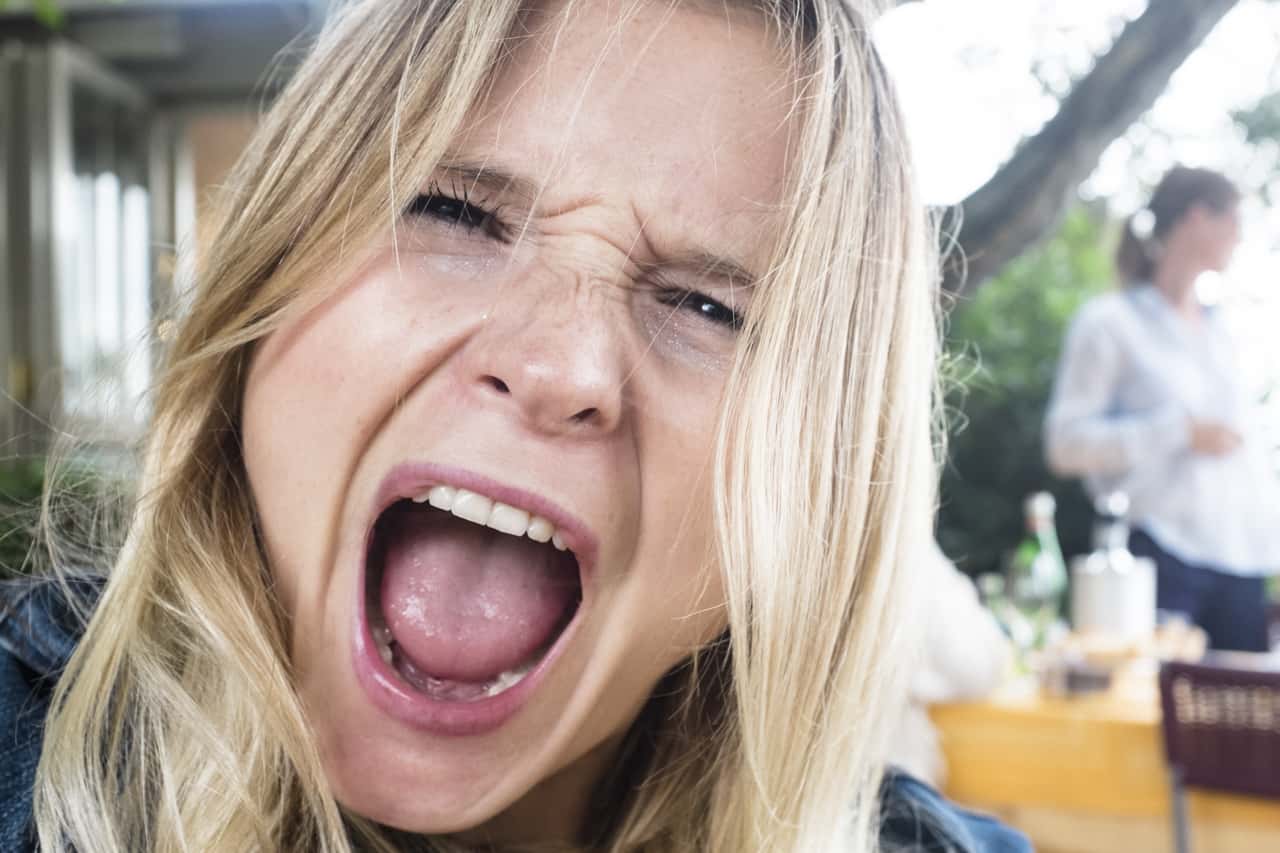 Woman shouting close-up portrait.