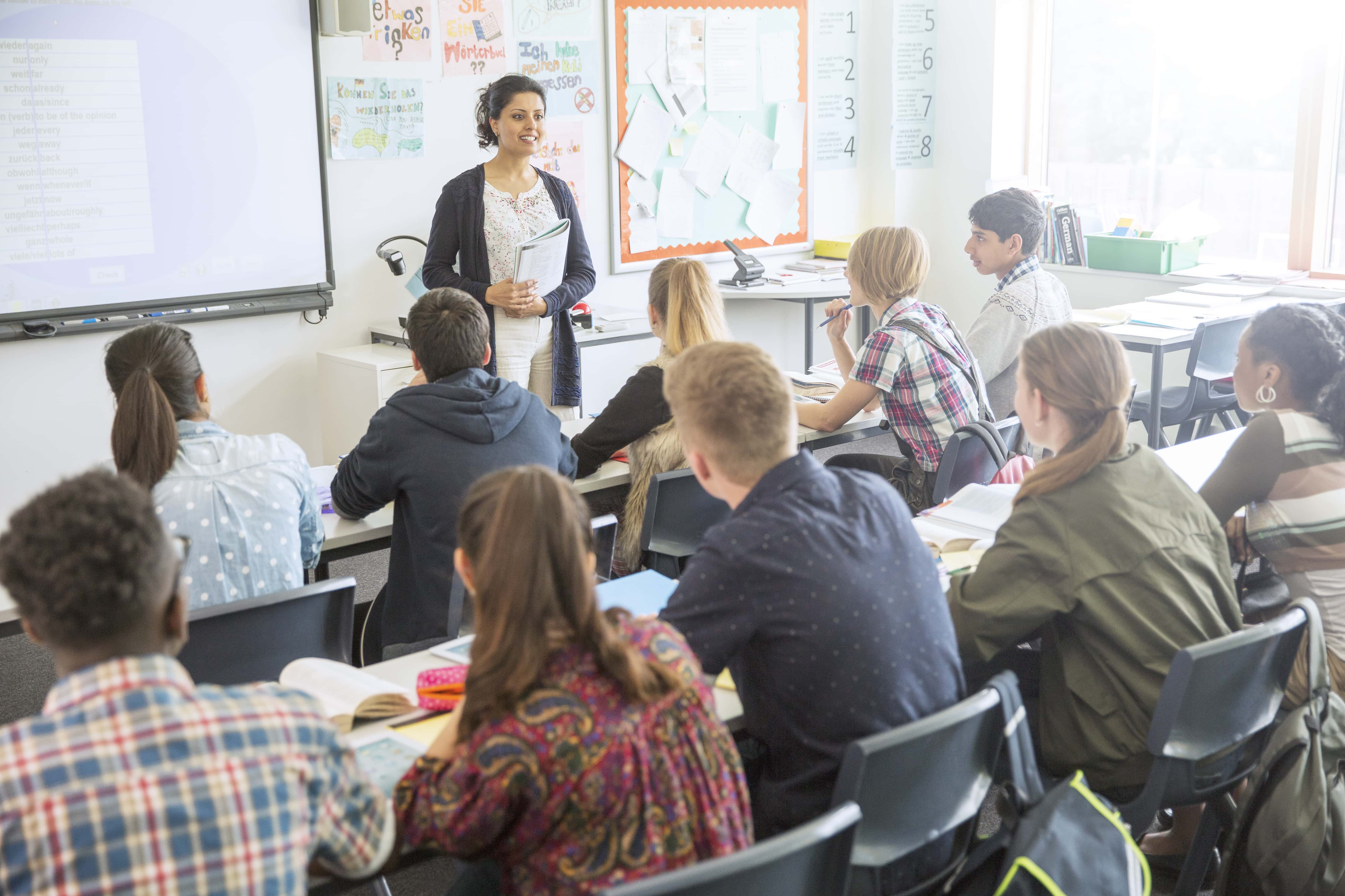 Teacher and students in classroom during lesson.