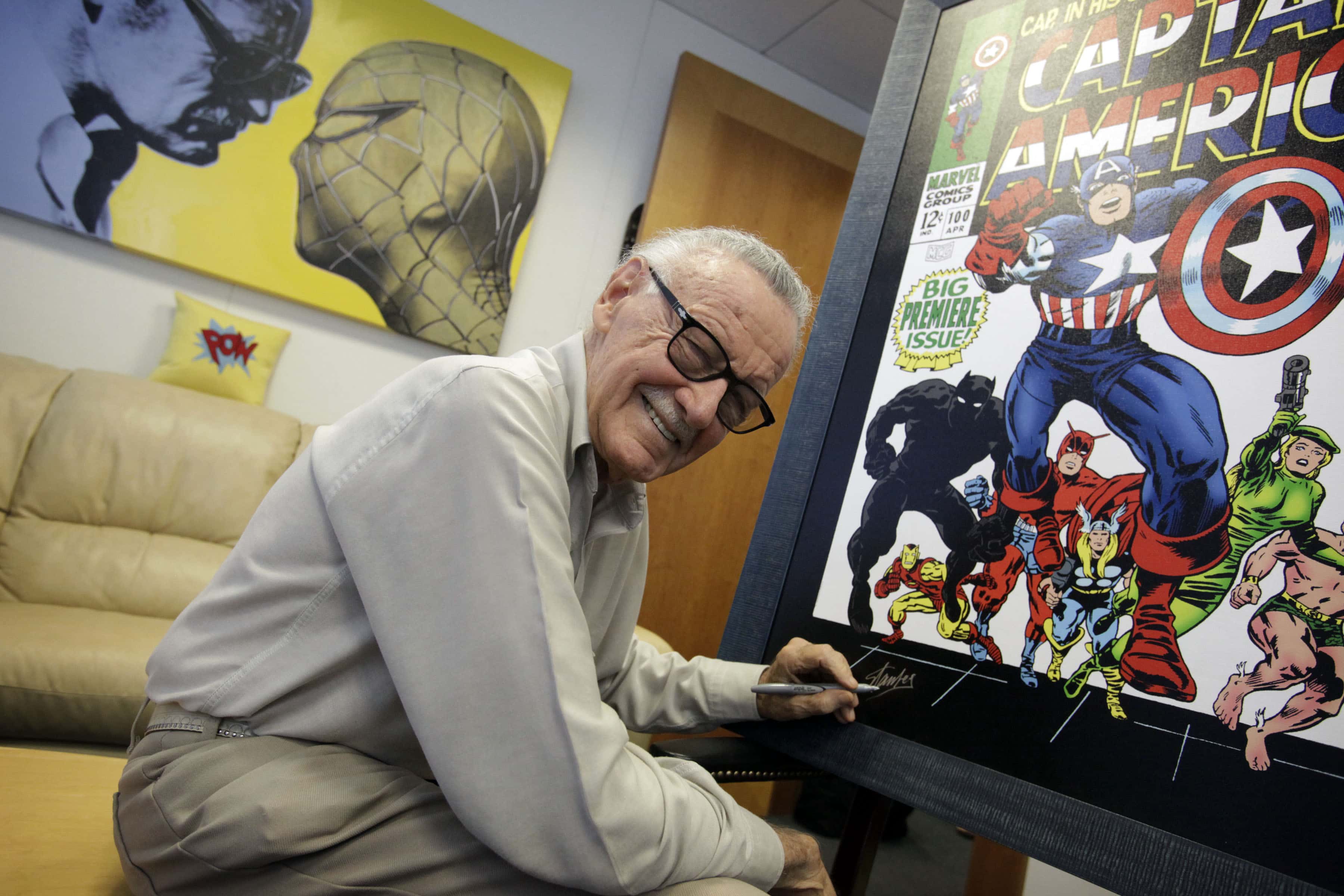 Stan Lee signing poster for an upcoming exhibit in his Beverly Hills office.